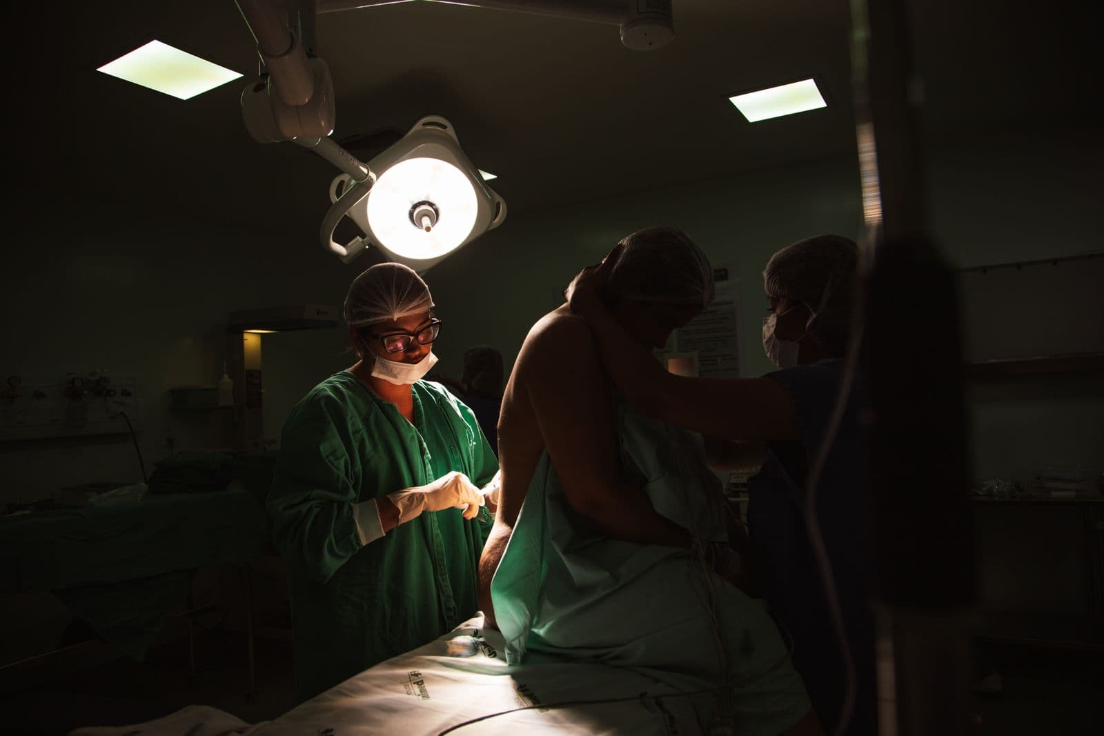 Surgical team working under lights in a modern operating room
