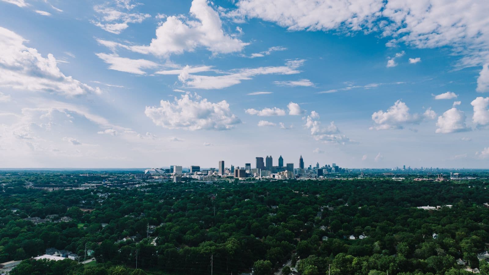 Aerial view of the Atlanta skyline surrounded by greenery